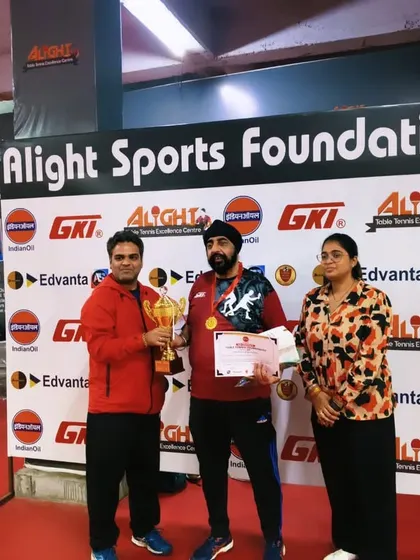 Presenting an award to a winner at the corporate tournament. The event saw over 900 matches played across 6 different categories.
