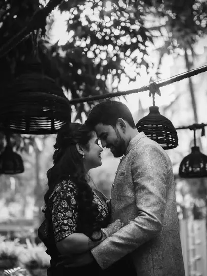 A quiet, intimate moment between Sanika and Amol, framed by the hanging lamps. This photo feels like they are in their own little world.