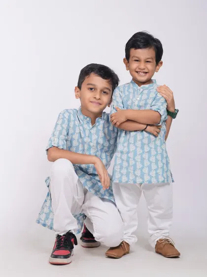 A heartwarming portrait of two brothers, with the older one protectively holding his younger sibling. A perfect capture of brotherly love.