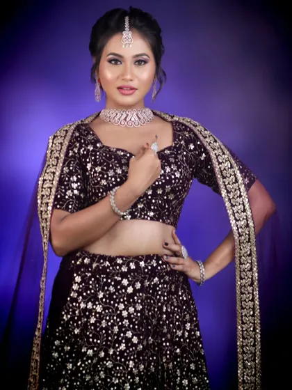 A glamorous reception look with a purple velvet lehenga, complemented by our sparkling diamond-look choker set.