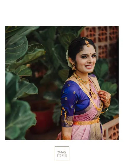 A classic bridal portrait against a backdrop of lush green leaves, highlighting the bride's natural beauty.