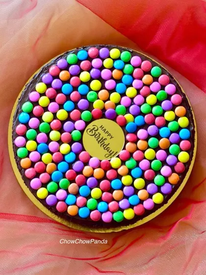 A simple and fun chocolate cake covered in colourful gems. This is a great cake for school celebrations or kids' parties where you want something easy to share.