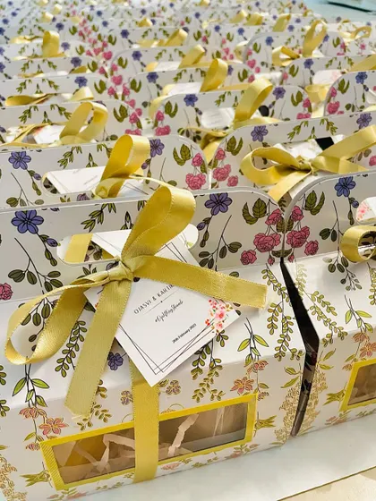 These floral-printed gift boxes with gold ribbons are perfect for engagement or wedding return favors. They can be filled with your choice of goodies.
