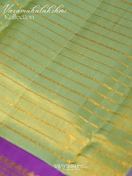 The body of the tissue saree features elegant horizontal zari lines, adding a subtle shimmer.
