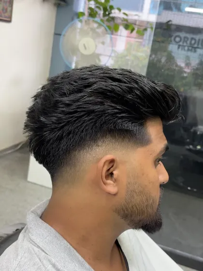 A side profile of a textured haircut with a mid-fade. This is a versatile look that can be styled in many different ways.