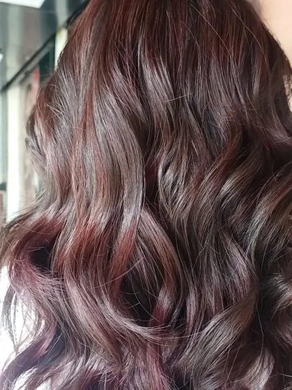 A gorgeous example of color blending with rich red and mahogany tones. This look was created without bleach, using a combination of balayage and babylights to weave different shades together for a seamless, dimensional result.
