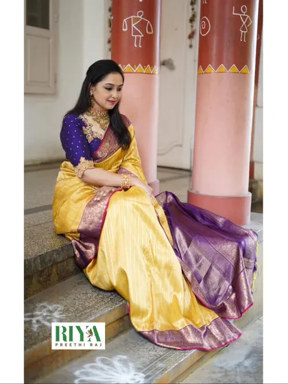 A seated portrait showing how the saree and blouse drape together. When I design, I think about how the outfit will look from every angle, whether you are standing, sitting, or celebrating. The goal is always elegance and comfort.