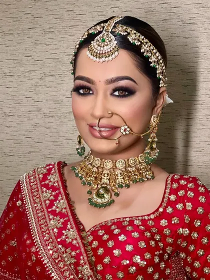 A full-face view of this classic bridal glam. The combination of bold eyes, a perfectly matched foundation, and traditional jewelry creates an unforgettable look.