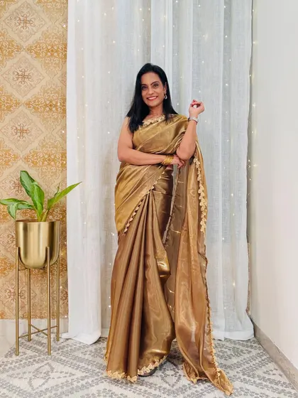 This golden organza ready-to-wear saree is perfect for a party. It's glamorous and festive, but without the hassle of draping.