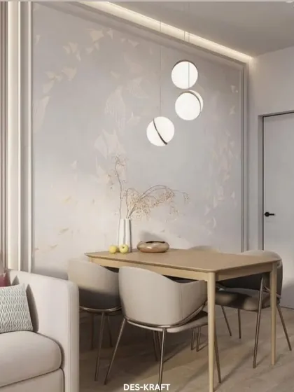 A serene dining area set against a wall with subtle, nature-inspired wallpaper and modern globe pendant lights, creating a calm and elegant atmosphere.