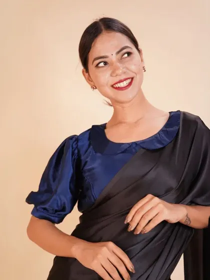 This royal blue satin blouse with a Peter Pan collar and puffed sleeves is a chic and stylish choice for a modern ethnic look.