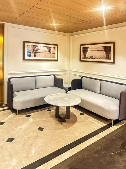 A comfortable seating nook in the Bhopal hotel, featuring contemporary sofas and a marble coffee table. We create these smaller zones within larger lobbies to offer guests more intimate spaces for conversation or rest.