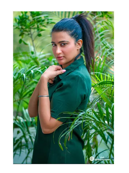 Another shot from the same location, with the model framed by plants. This composition creates a beautiful connection with nature.