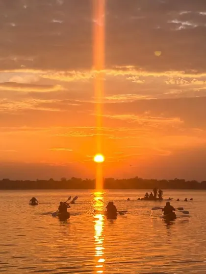 A magical sunset at Vani Vilas Sagar, with kayakers enjoying the last light of the day on the water.