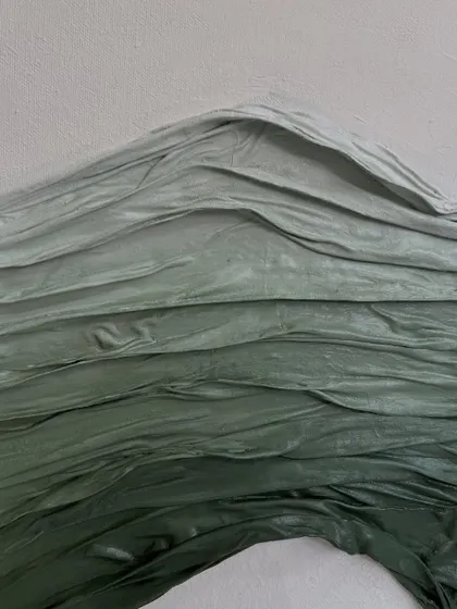 A macro detail shot of the gradient in the green fabric texture. You can see the subtle shifts in color from light to dark green, adding another layer of visual interest.