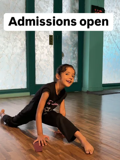 A happy dancer achieving her split. This moment captures the joy of seeing hard work pay off.