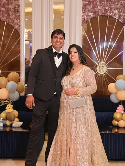 A golden moment for this lovely couple. My client is wearing a full-length golden gown with intricate detailing, perfect for a reception or anniversary celebration.