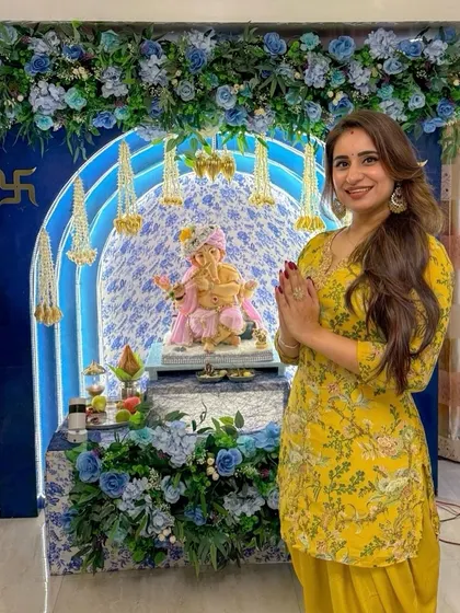 Presenting our colour of the season, 'Aqua Blue'. This Ganpati mandap features a stunning floral arch in shades of blue and white, with delicate hanging mogra strings. It's an elegant and fresh take on festive home decor.