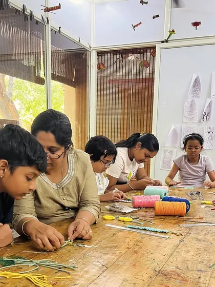 Our macrame class is in full swing! Here, I'm providing guidance as students learn to create intricate patterns with knots. It's a collaborative and supportive learning environment.