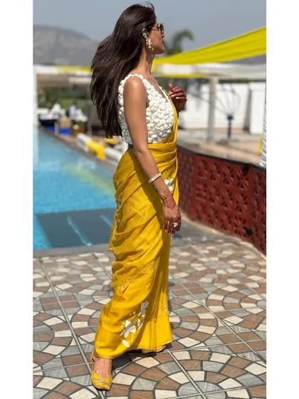 The wind catching the saree's pallu shows off its light, airy quality. This is a great example of how choosing the right fabric can add movement and life to your look.