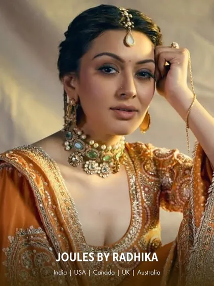 Hansika Motwani adorned in a beautiful pastel green choker, matching earrings, and a maang tikka, creating a soft and regal look.