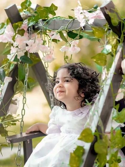 A true angel in our garden. This little girl's happy expression while sitting on the floral swing is absolutely priceless.
