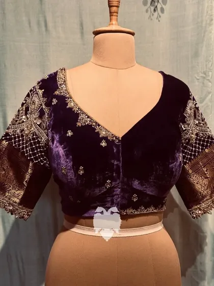 A frontal view of the violet velvet blouse, showing the sparkling buttas and detailed sleeves.
