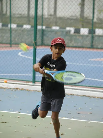 With eyes on the ball, this young champion is learning the fundamentals of a solid forehand. Our orange ball program helps bridge the gap to full-court tennis, making the transition smoother and more effective.
