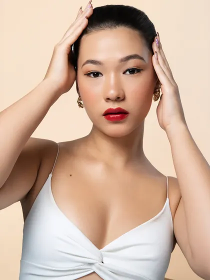 This image demonstrates how a classic red lip and winged liner can be both powerful and playful. The clean makeup look is perfect for any party or special occasion.