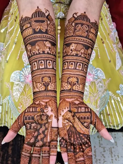 This intricate design covers the hands from fingertips to elbow, packed with wedding scenes, royal elephants, and portraits of the couple.