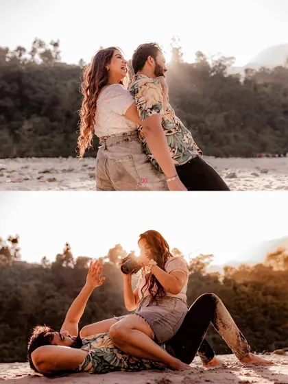 A playful and fun pre-wedding shot of the couple on a sandy riverbank, with the bride pretending to take a photo of her partner.