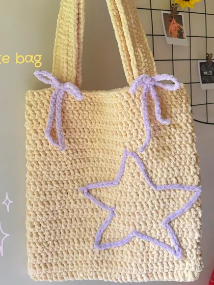 A closer look at the texture and details of my star and bow crochet tote bag. The plush yarn makes it super soft to the touch while being sturdy enough for everyday use.