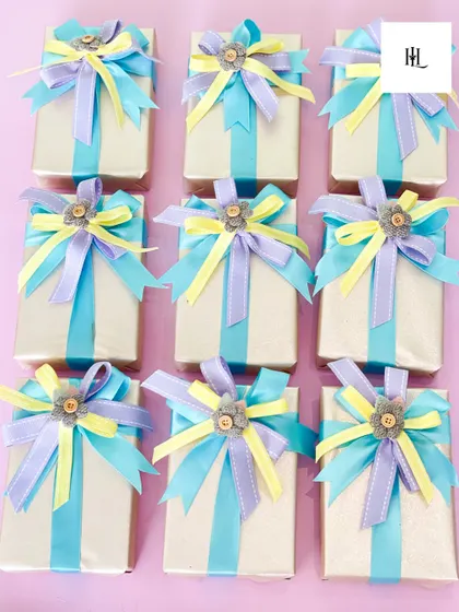 More examples of my detailed gift wrapping. The combination of pastel ribbons creates a soft and cheerful look, perfect for a happy occasion.