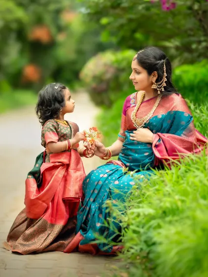 A heartwarming moment between a mother and daughter, as the little one offers her mom a flower.