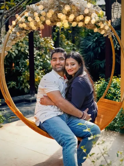 The same couple enjoying their pre-wedding shoot on the lighted swing, capturing their relaxed and happy expressions.