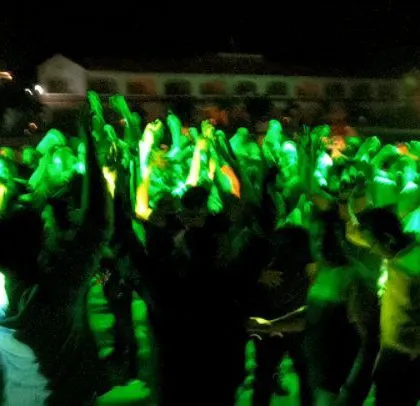 The dance floor is a sea of green light and happy faces. This corporate event was a total banger with non-stop dancing.