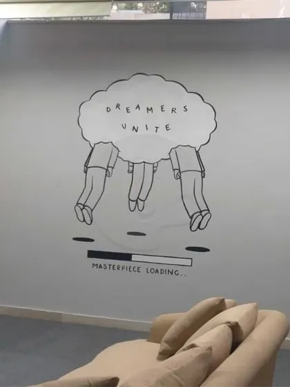 A minimalist and conceptual doodle art piece for an office in Gurgaon. Featuring the phrase "Dreamers Unite," this mural is perfect for a creative agency or startup looking for subtle, thought-provoking art.