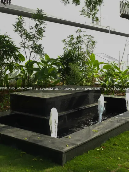 A side view of the modern water fountain, showing the water spouts and the depth of the basin.