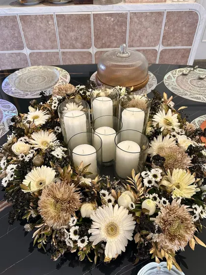 This overhead view shows the full wreath-style centerpiece on the dining table. It's a statement piece that still allows guests to see and talk to each other across the table.