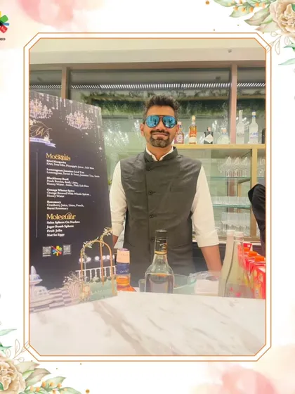 Our expert mixologist, ready to serve at a high-end event. His professional demeanor and well-stocked bar signal a premium experience.