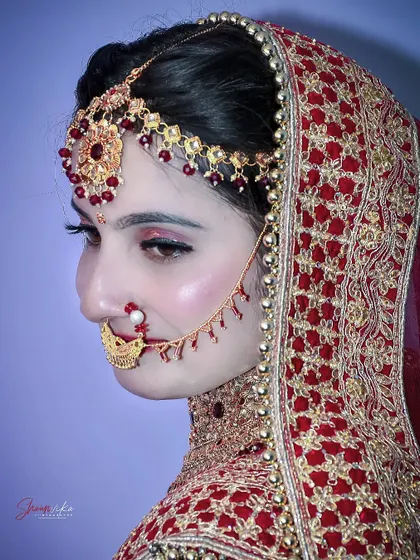 A stunning side profile of the bride, showcasing her elaborate hair and makeup for the big day.
