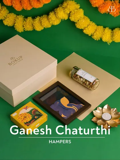 Our Ganesh Chaturthi hampers are now live. This beautiful flat-lay showcases a Ganesha-themed frame, a jar of pistachios, and a lotus diya.
