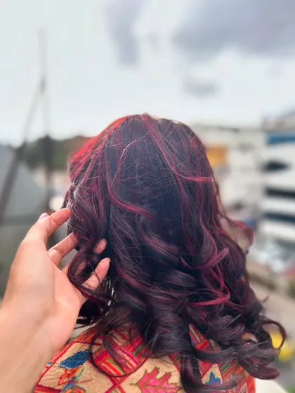 A close-up of the rich red tones and healthy shine achieved through our professional coloring process. We train students on techniques that ensure vibrant color without compromising hair health.