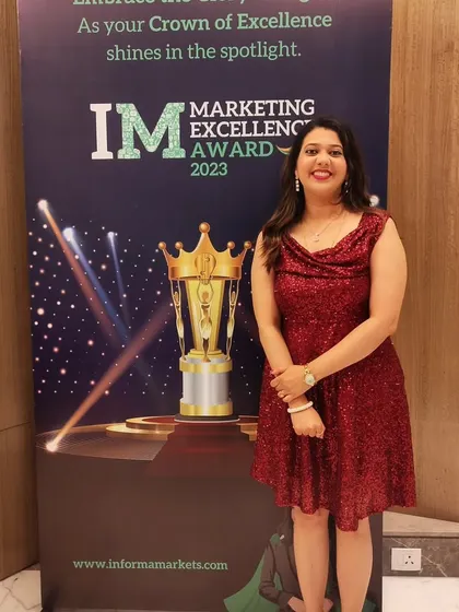 Posing by the official event banner for the Marketing Excellence Awards 2023. It was an honor to be the chosen anchor for an evening celebrating the best in the marketing industry.