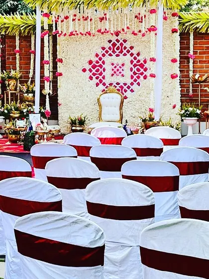 An identical view of the Seemantham guest seating, highlighting the beautiful floral stage in the background.