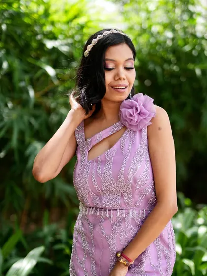 A close-up of the lavender gown, showing the delicate beading and the unique one-shoulder design.