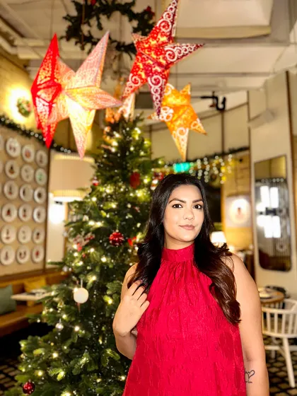Getting into the festive spirit with this beautiful red halter-neck dress. It's the perfect color for a Christmas party.