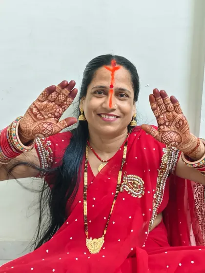 The heart of every Chhath celebration. A mother proudly displays her festive mehndi, ready for the puja.
