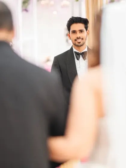 The groom's face says it all. This is the moment he sees his bride walking down the aisle towards him. It's a look of pure love and anticipation.