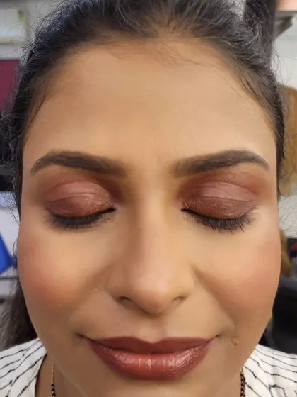 Eyes closed to showcase the soft blend of the brown smokey eye. The colors are melted together to avoid any harsh lines for a seamless finish.